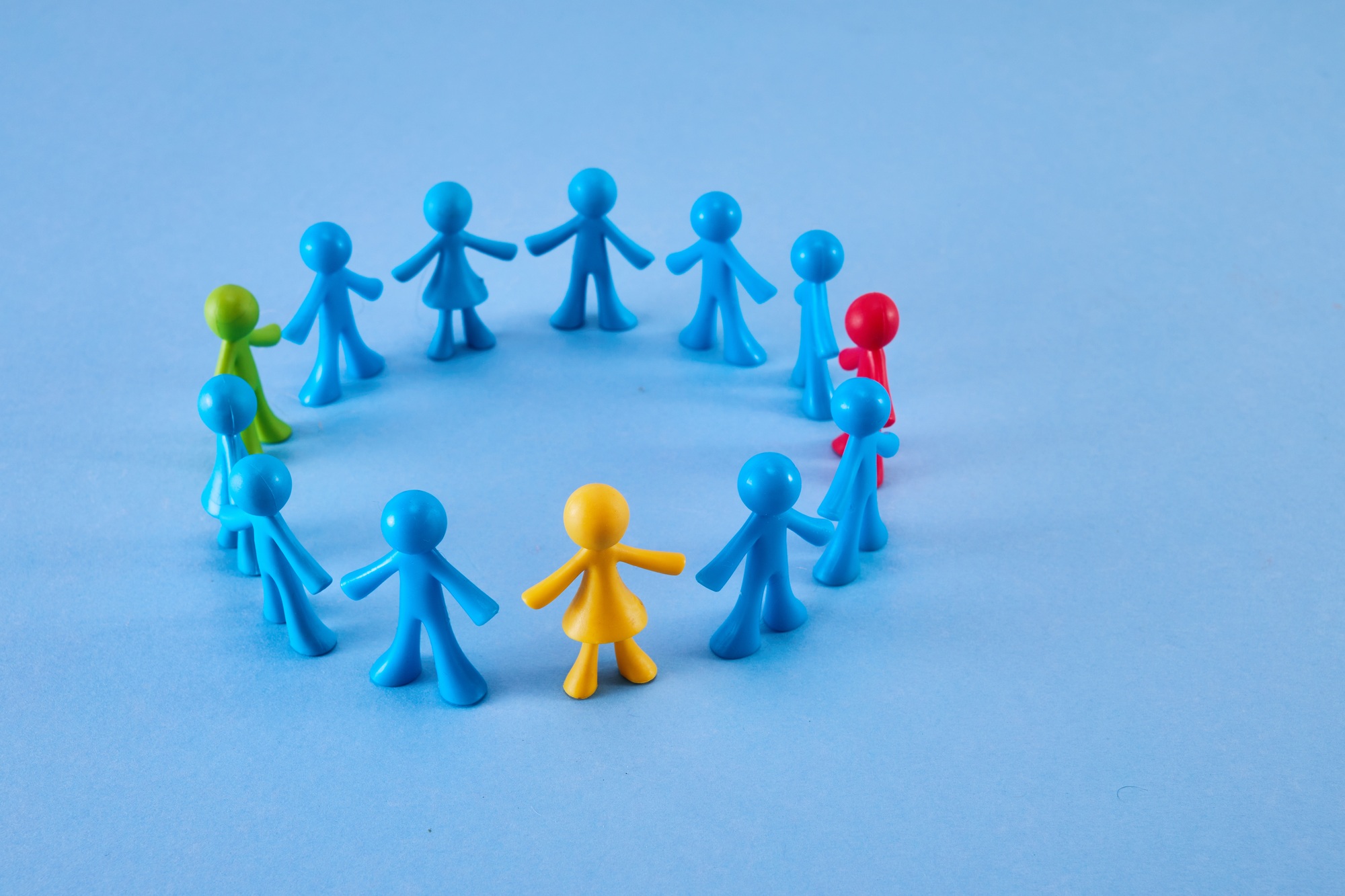 Diversity and inclusion concept. Colorful figurines on blue background